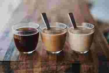 Three cups of coffee with different amounts of milk